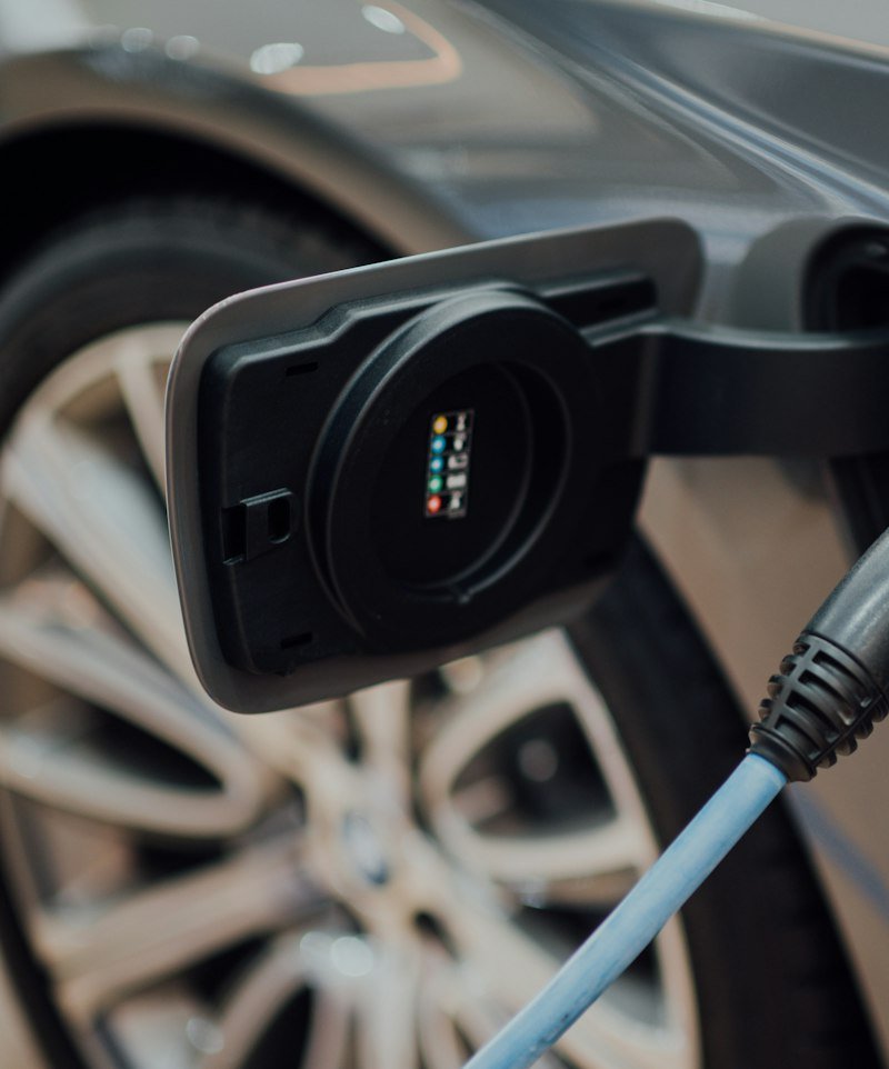 Electric vehicle charging connector plugged into a car