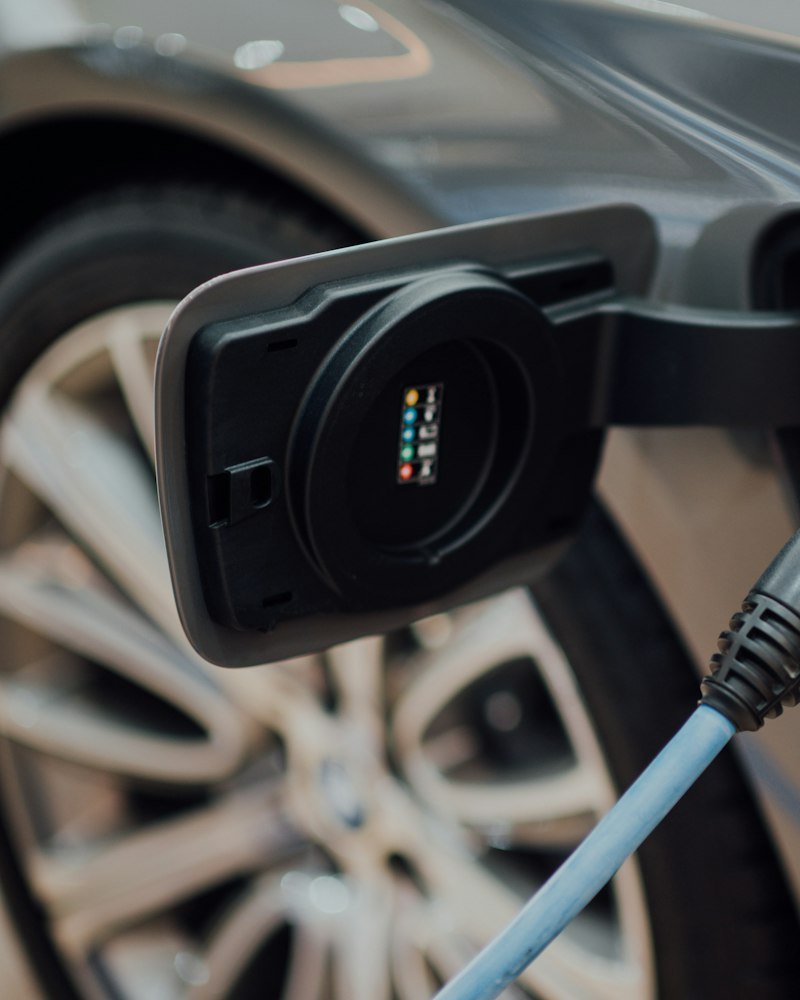 DC fast charging connector plugged into an electric vehicle